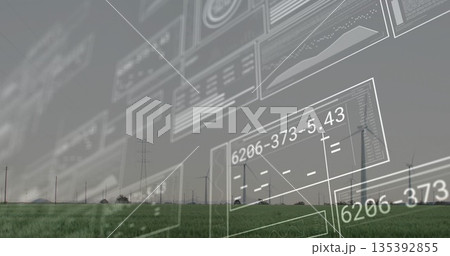 Displaying digital panels projecting readouts over green grass field, with wind turbines on horizon Displaying digital panels projecting readouts over green grass field, with wind turbines on horizon 135392855