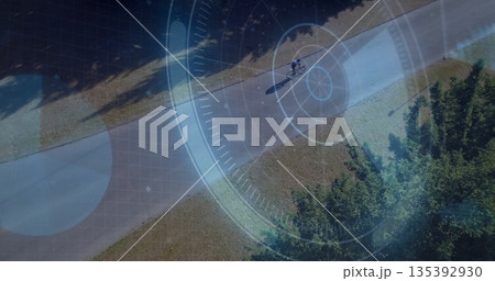 Riding teen cyclist wearing helmet, cycling shorts on bicycle through park, HUD overlay, copy space Riding teen cyclist wearing helmet, cycling shorts on bicycle through park, HUD overlay, copy space 135392930