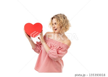Woman playfully shows a big red heart, isolated, PNG 135393018