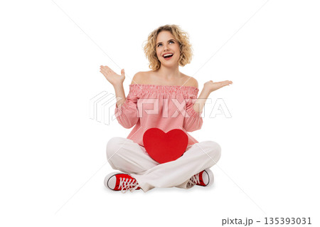 Joyful young woman with curly hair and a heart, isolated, PNG Joyful young woman with curly hair and a heart, isolated, PNG 135393031