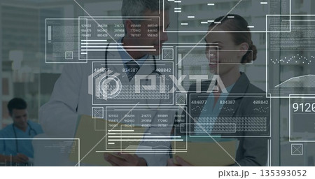 Reviewing records doctor in lab coat and executive in suit at hospital, with folders, stethoscope 135393052