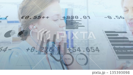 Using stethoscope, provider in scrubs examining patient chest at office bookcase, with digital data 135393098