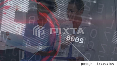 Reviewing two medical professionals examining tablet and clipboard in clinical lab, HUD graphics 135393109