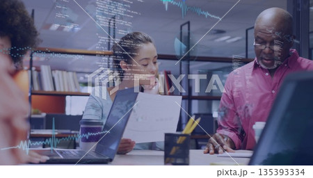 Reviewing printed reports, three professionals analyzing charts in library office, with laptops Reviewing printed reports, three professionals analyzing charts in library office, with laptops 135393334