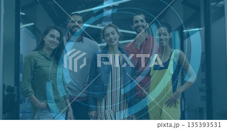 Collaborating team using blue holographic interface in open office, glass partitions and LED lights 135393531