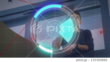 Reaching forward technician operating console in control room, using holographic radar interface Reaching forward technician operating console in control room, using holographic radar interface 135393660