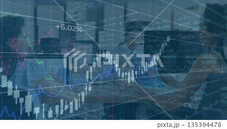 Sitting finance team analyzing data on monitors in modern office, with floating stock graphs 135394478