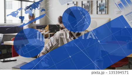 Writing senior man wearing checkered shirt working on laptop at office table, with network graphics 135394571