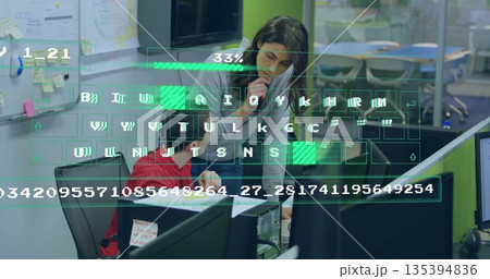 Collaborating coworkers writing printed document at office desk with phone and digital overlay 135394836