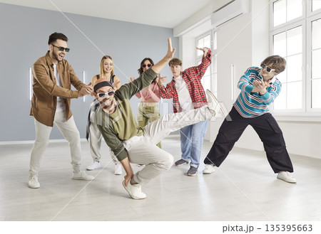Group of young people practice urban dance in modern studio Group of young people practice urban dance in modern studio 135395663