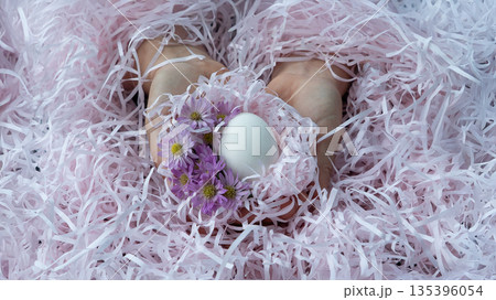 Easter Egg in Hands with Spring Flowers Easter Egg in Hands with Spring Flowers 135396054