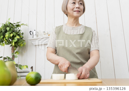 キッチンで楽しく料理をするシニア女性 キッチンで楽しく料理をするシニア女性 135396126
