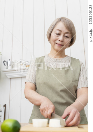 キッチンで楽しく料理をするシニア女性 キッチンで楽しく料理をするシニア女性 135396128