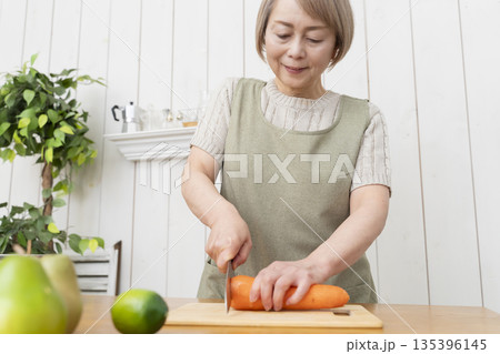 キッチンで楽しく料理をするシニア女性 キッチンで楽しく料理をするシニア女性 135396145