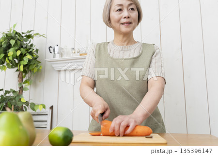 キッチンで楽しく料理をするシニア女性 135396147