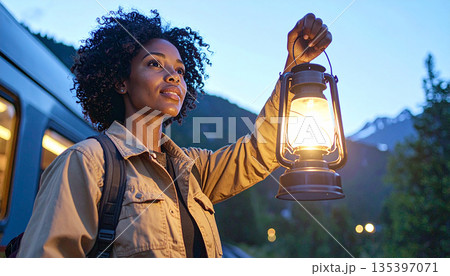 Close Up of Woman Stationmaster Signaling with Lantern at Blue Hour Close Up of Woman Stationmaster Signaling with Lantern at Blue Hour 135397071