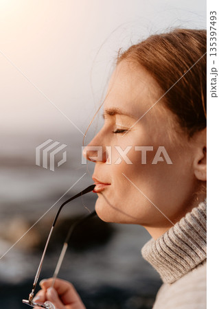 Woman Glasses Outdoors Relaxation: Peaceful profile portrait, serene expression, sunset. Woman Glasses Outdoors Relaxation: Peaceful profile portrait, serene expression, sunset. 135397493