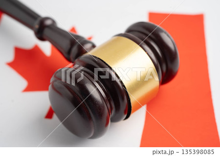 Canada law, Legal, justice and agreement, wooden court gavel on flag. 135398085