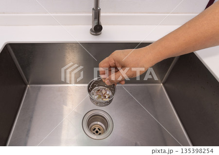 Food scraps in the basket strianer of sink Food scraps in the basket strianer of sink 135398254
