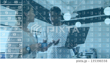 Women in suits reviewing flight plan in aircraft hangar, with private jet tablet currency overlay 135398338