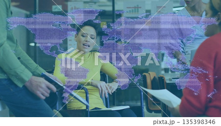 Leading woman in wheelchair guiding office team using digital map, tablet and documents Leading woman in wheelchair guiding office team using digital map, tablet and documents 135398346