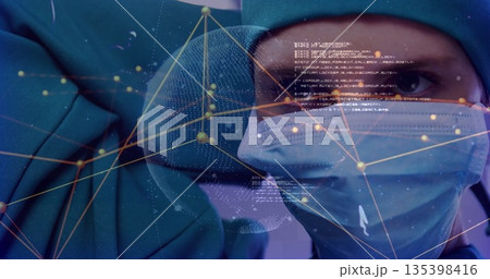 Displaying surgeon wearing cap mask and gown in OR suite scanning network code overlay, copy space Displaying surgeon wearing cap mask and gown in OR suite scanning network code overlay, copy space 135398416