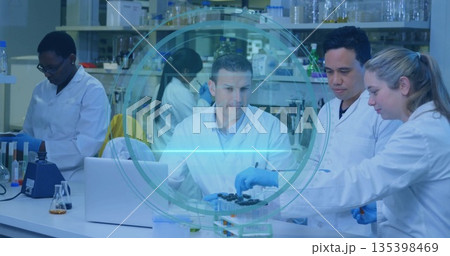 Conducting experiments five scientists in lab coats and gloves at lab bench, with test tubes Conducting experiments five scientists in lab coats and gloves at lab bench, with test tubes 135398469