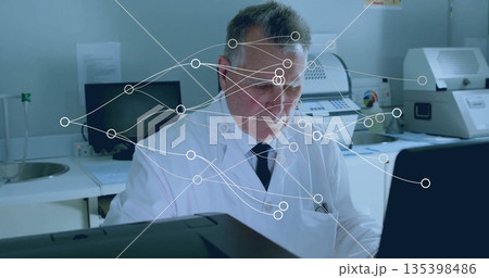 Analyzing technician wearing lab coat and tie focusing on computer screen in lab, with data overlay Analyzing technician wearing lab coat and tie focusing on computer screen in lab, with data overlay 135398486