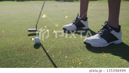 Aligning golfer's legs next to golf ball on putting green, with putter and black-and-white shoes Aligning golfer's legs next to golf ball on putting green, with putter and black-and-white shoes 135398494