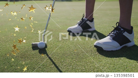 Aligning female golfer legs in spiked shoes on green, with putter, golf ball and golden sparkles Aligning female golfer legs in spiked shoes on green, with putter, golf ball and golden sparkles 135398501