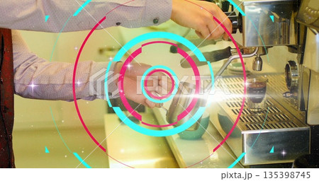 Frothing barista hands creating microfoam at coffee counter, with milk pitcher and red tie detail 135398745