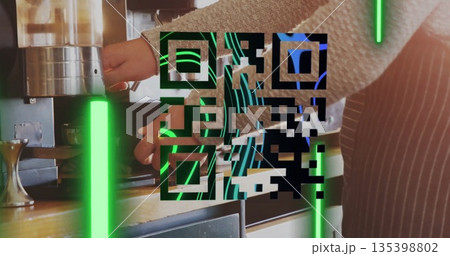 Barista in apron securing portafilter under espresso maker at coffee counter with neon QR code bars 135398802