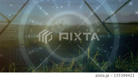 Emerging grass blades displaying HUD in greenhouse, with arrows, triangles, crosses and circuitry 135399421