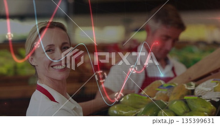 Smiling worker wearing red apron sorting produce in produce aisle with graphs overlay, copy space Smiling worker wearing red apron sorting produce in produce aisle with graphs overlay, copy space 135399631
