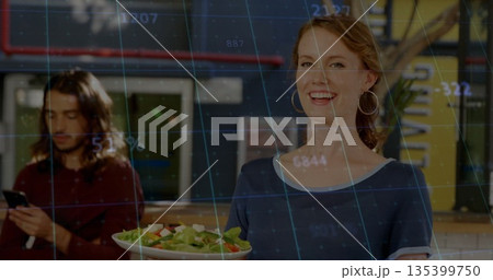 Holding server in navy tee presenting fresh salad at cafe counter showing data overlay, copy space 135399750