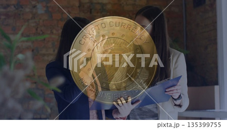 Reviewing blue binder women wearing navy and tan blazers in brick-wall office, with NFT overlay 135399755