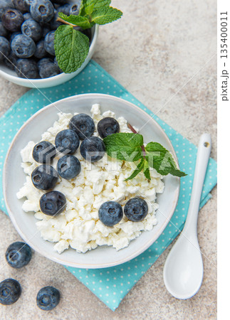 Cottage cheese with blueberries and fresh mint leaves Cottage cheese with blueberries and fresh mint leaves 135400011