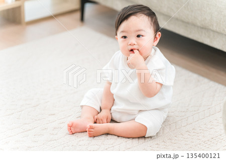 マイホームのリビングにお座りする赤ちゃん マイホームのリビングにお座りする赤ちゃん 135400121