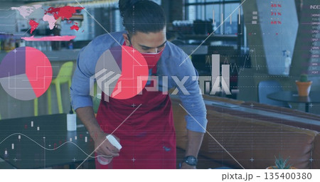 Cleaning server wearing red apron and mask spraying table with bottle at café, with charts Cleaning server wearing red apron and mask spraying table with bottle at café, with charts 135400380