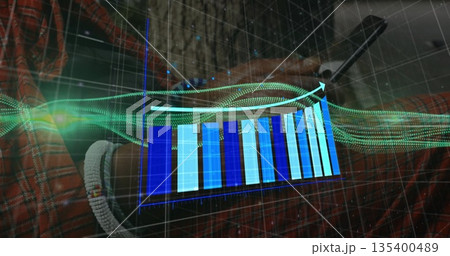 Analyzing smartphone data in office, showing holographic bar chart and green data-stream visuals 135400489