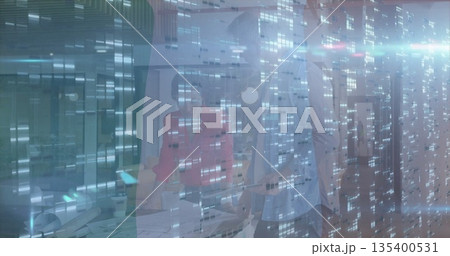 Woman in red blazer and colleague examining documents, laptop at conference table with digital grid 135400531