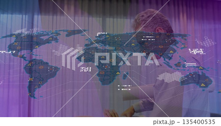 Presenting businessman in shirt gesturing at world map in office with warning markers copy space 135400535