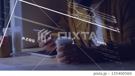 Man's hands holding smartphone and coffee cup, tapping tablet at cafe table with digital overlays 135400560