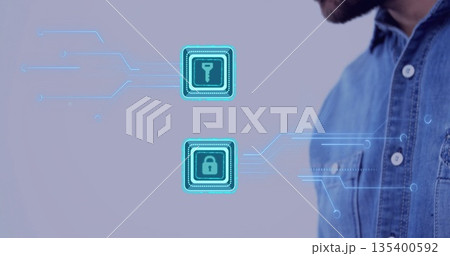 Gazing denim-shirted male examining holographic key and padlock icons on purple wall, copy space 135400592