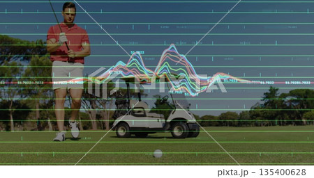 Walking male golfer holding golf club on fairway with ball, cart, glove, gridlines, copy space 135400628