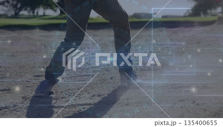 Standing mature male spreading legs on dry field in park, with denim pants, sneakers, data overlay 135400655