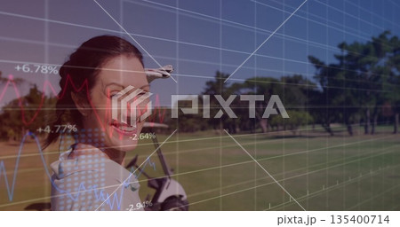 Smiling woman wearing polo shirt, golf glove carrying bag on golf fairway, data overlay, copy space 135400714