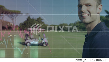 Standing smiling man wearing navy polo on golf fairway, with golf cart, data overlay, copy space 135400727