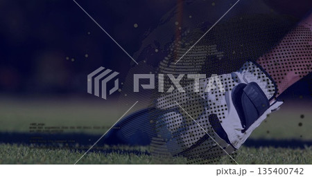 Placing white and black glove holding white golf ball on fairway, with digital globe, code overlays 135400742