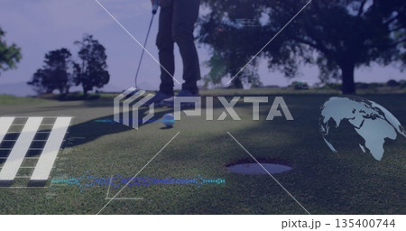 Aligning mature male golfer lining up putt on putting green, with putter and white golf ball 135400744